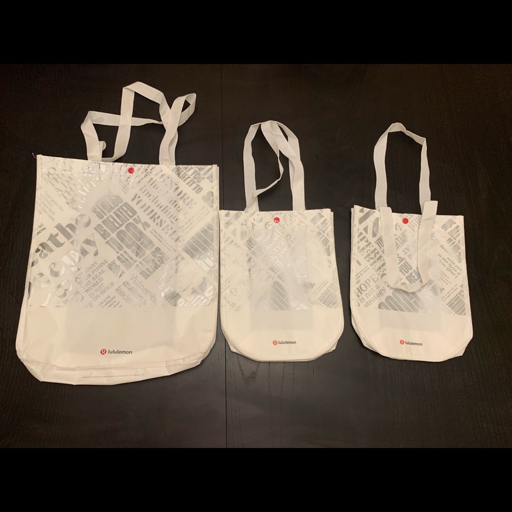 Three Lululemon Tote Bags with button snap closure (1 large and 2 small bags)